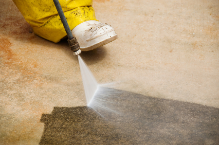 Blue Meadow Landscaping Victoria power washes a patio and driveway, showing a contrasting clean from before and after.